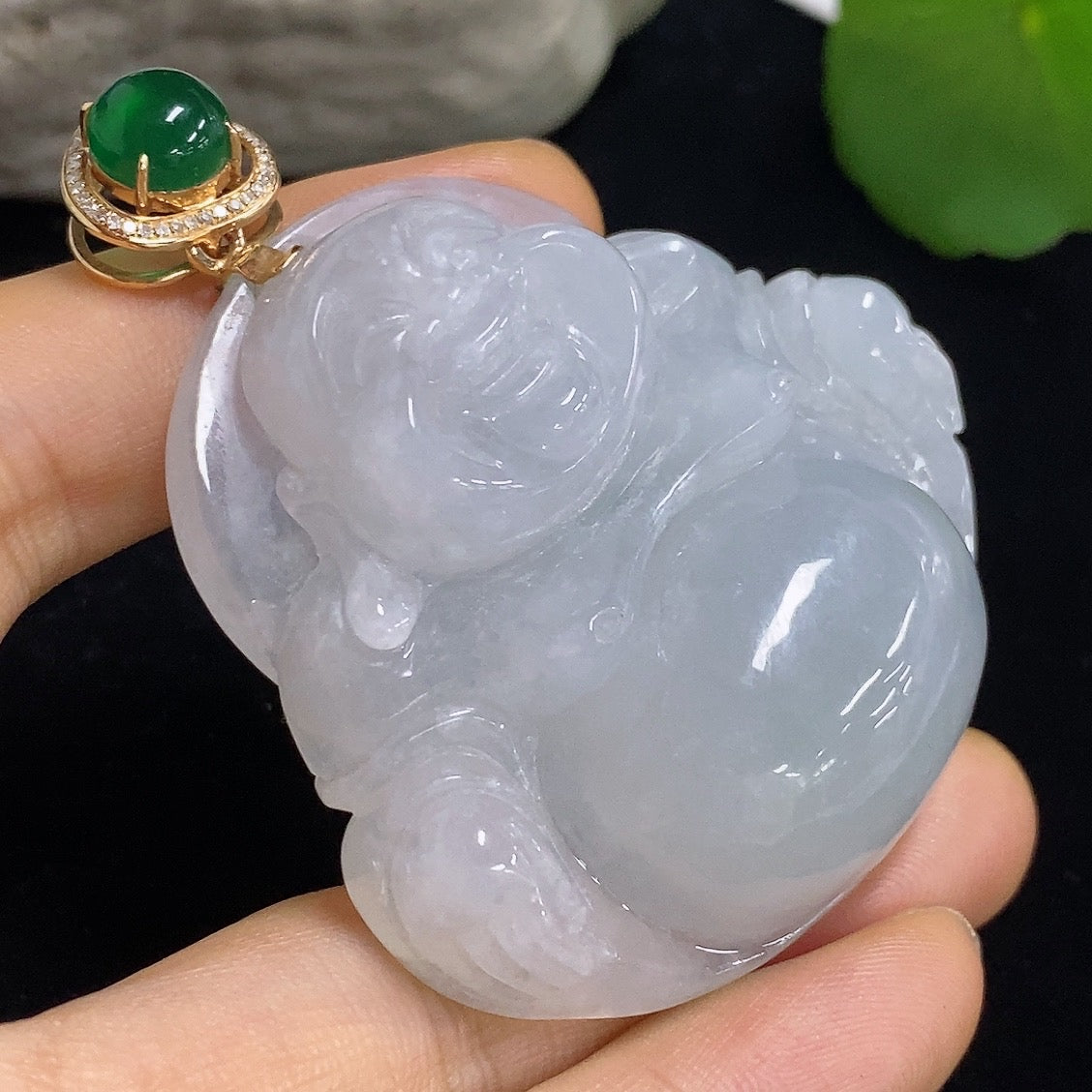 Jadeite Buddha pendant necklace with 18K gold and diamond accents, featuring a green cabochon jadeite Buddha charm.