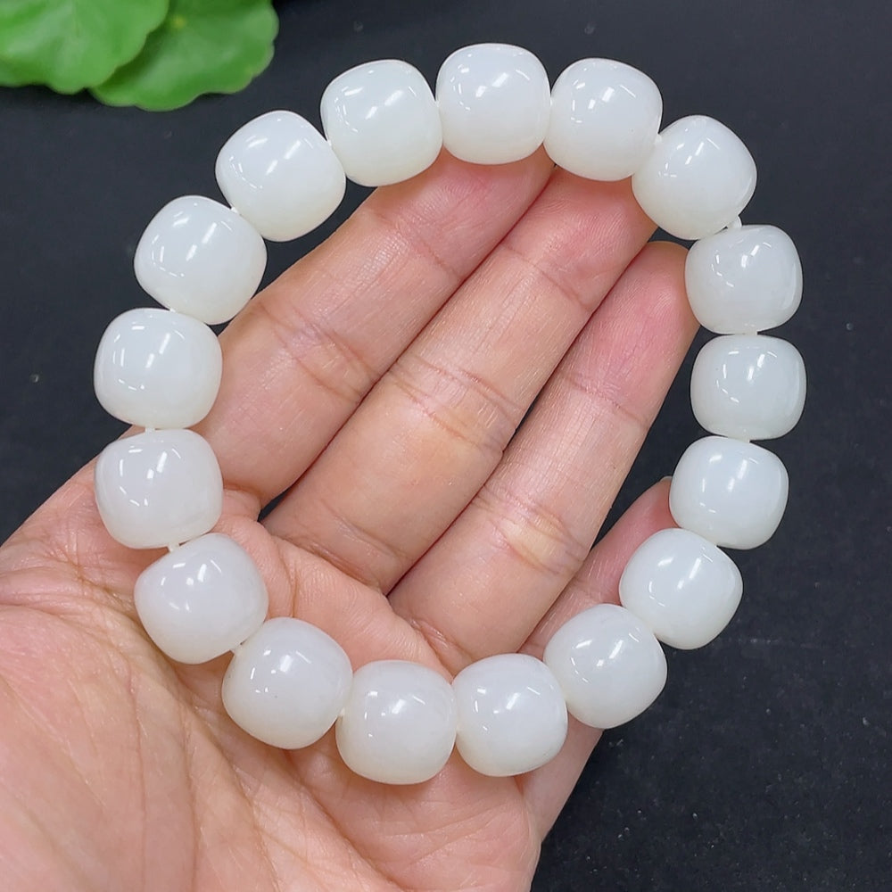 Hetian Jade bracelet by HKHQ featuring smooth, polished jade beads in a natural green hue, weighing 60.5 grams.