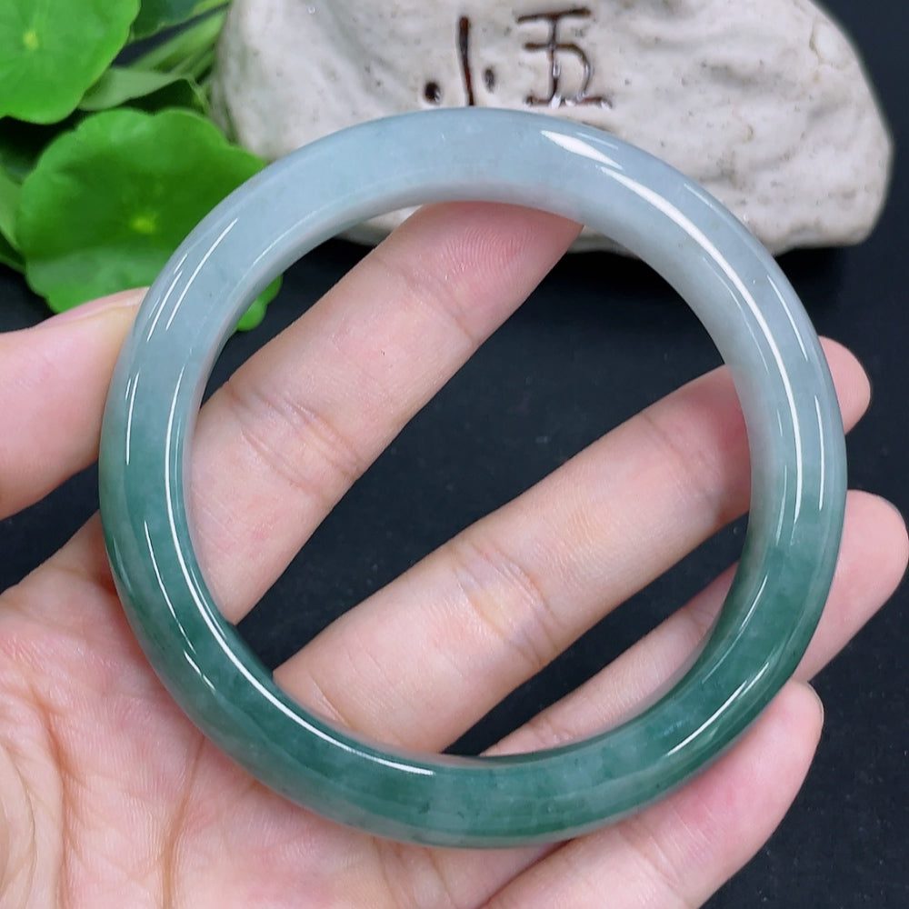 HKHQ jadeite round bangle with 58.9g weight and 58.8mm size, showcasing smooth, polished green jade surface.