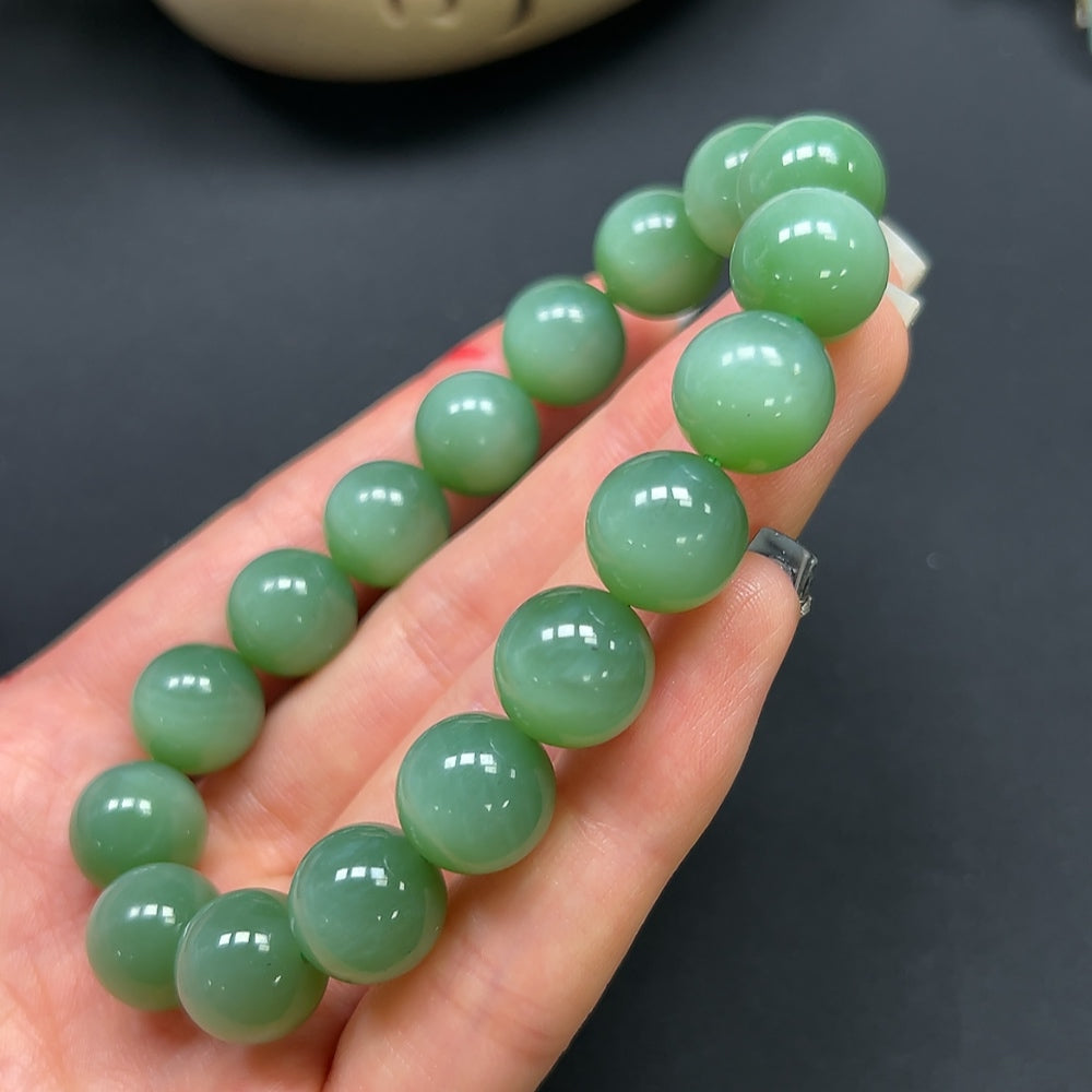 HKHQ Hetian Jade bracelet with 12mm beads, approximately 45.9g, showcasing smooth, polished jade stones strung together.
