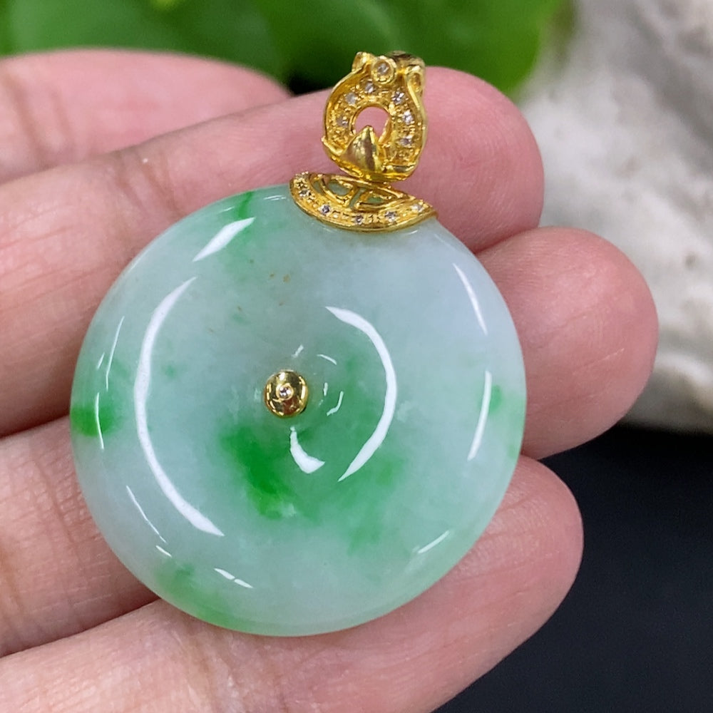Jadeite Peace Knot pendant with 18K gold clasp and diamond accents, showcasing intricate design and polished jade surface.