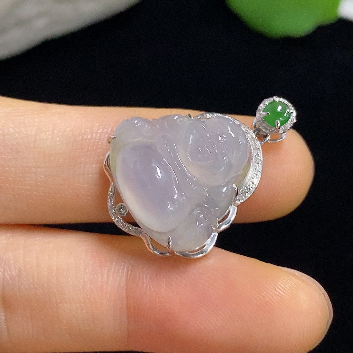 Jadeite Buddha pendant with 18k gold accents and diamond details, showcasing a detailed carved jade Buddha figure.