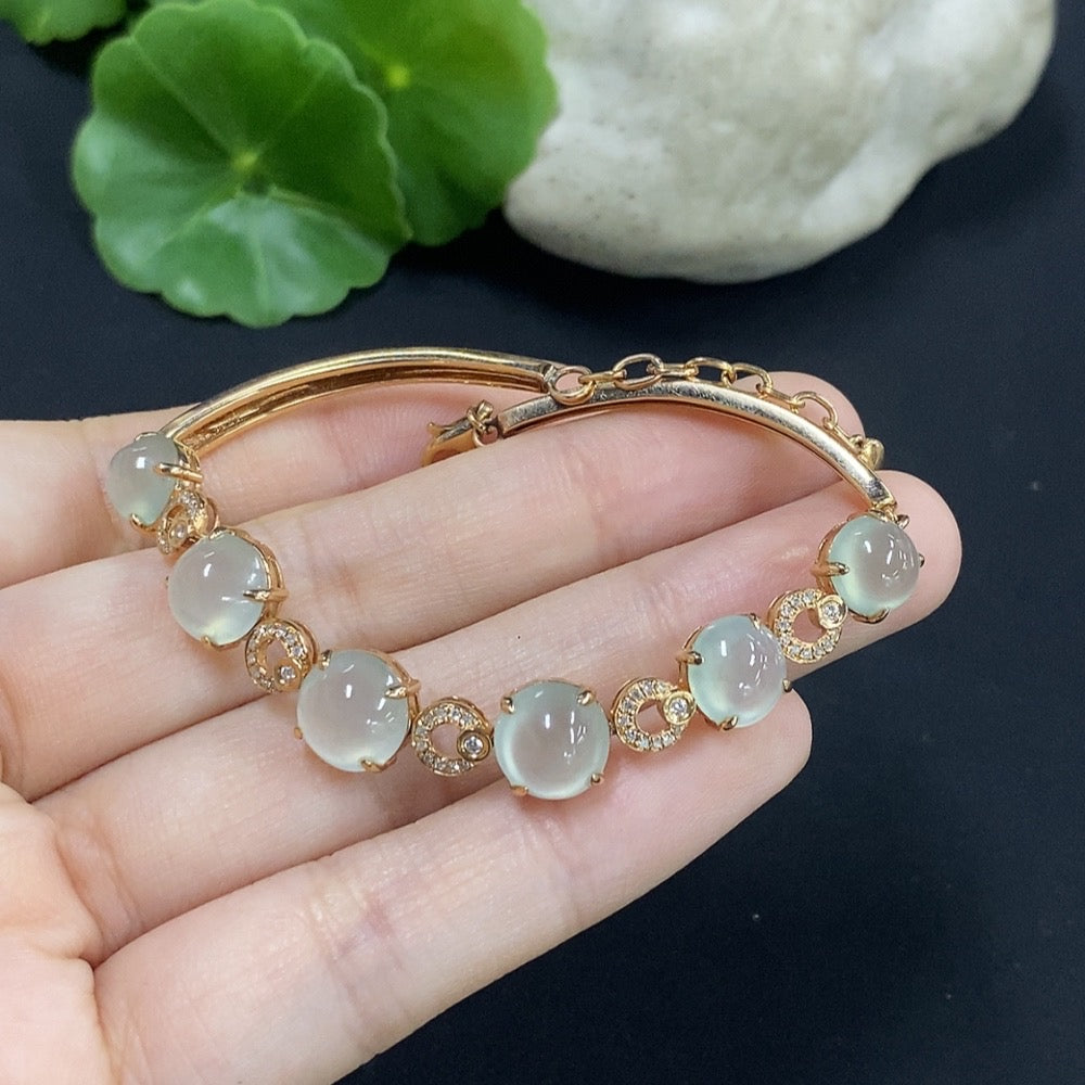 Jadeite cabochon bracelet set in 18K gold with diamond accents, total weight approximately 10.85g