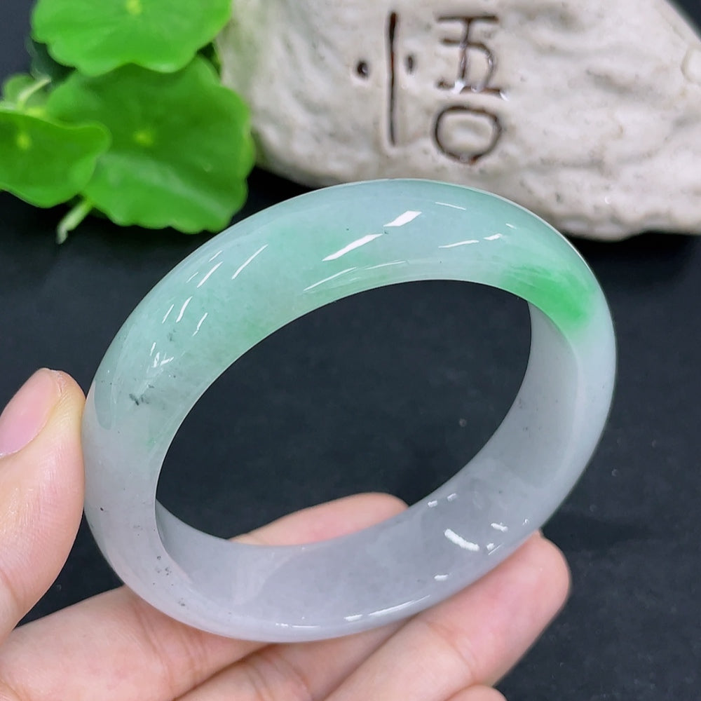 HKHQ jadeite round bangle with a 66.8g weight and size 55.7mm, showcasing smooth, polished green jade in a circular design.
