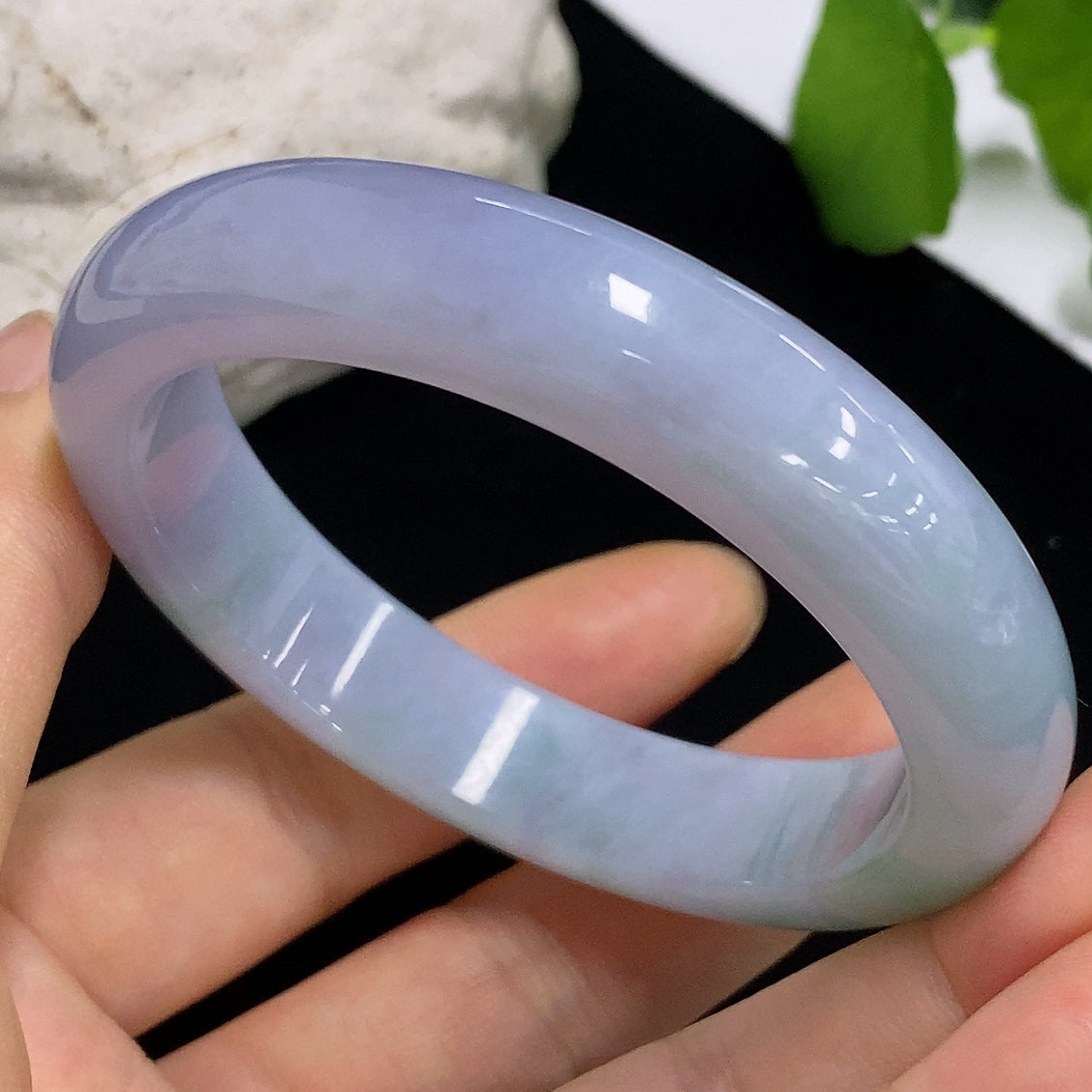 HKHQ jadeite round bangle in size 54.5 with a smooth polished surface, showcasing its vibrant green color and elegant craftsmanship.