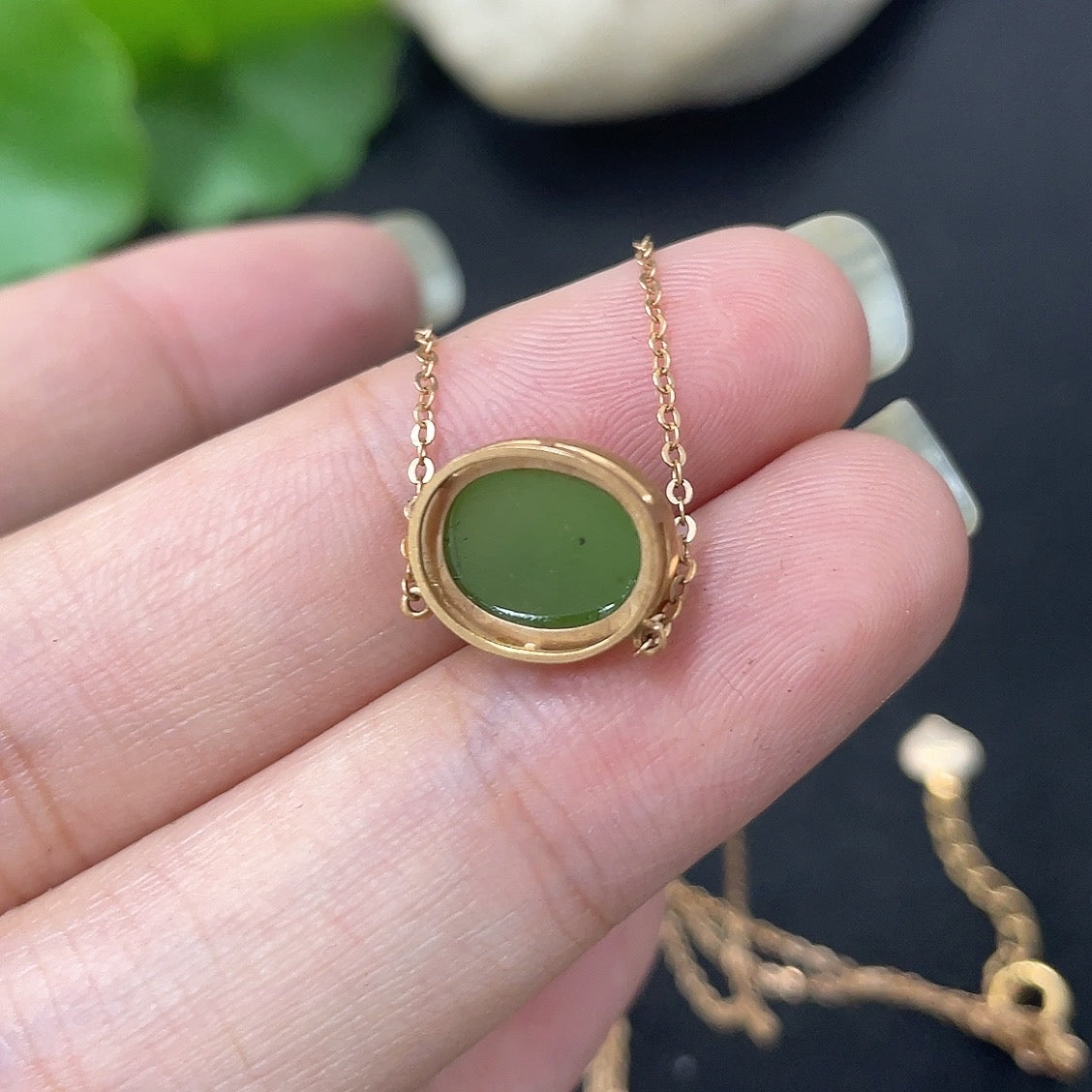 Hetian Jade inlaid pendant necklace with 18k gold setting, HKHQ brand, featuring a delicate jade stone and chain.