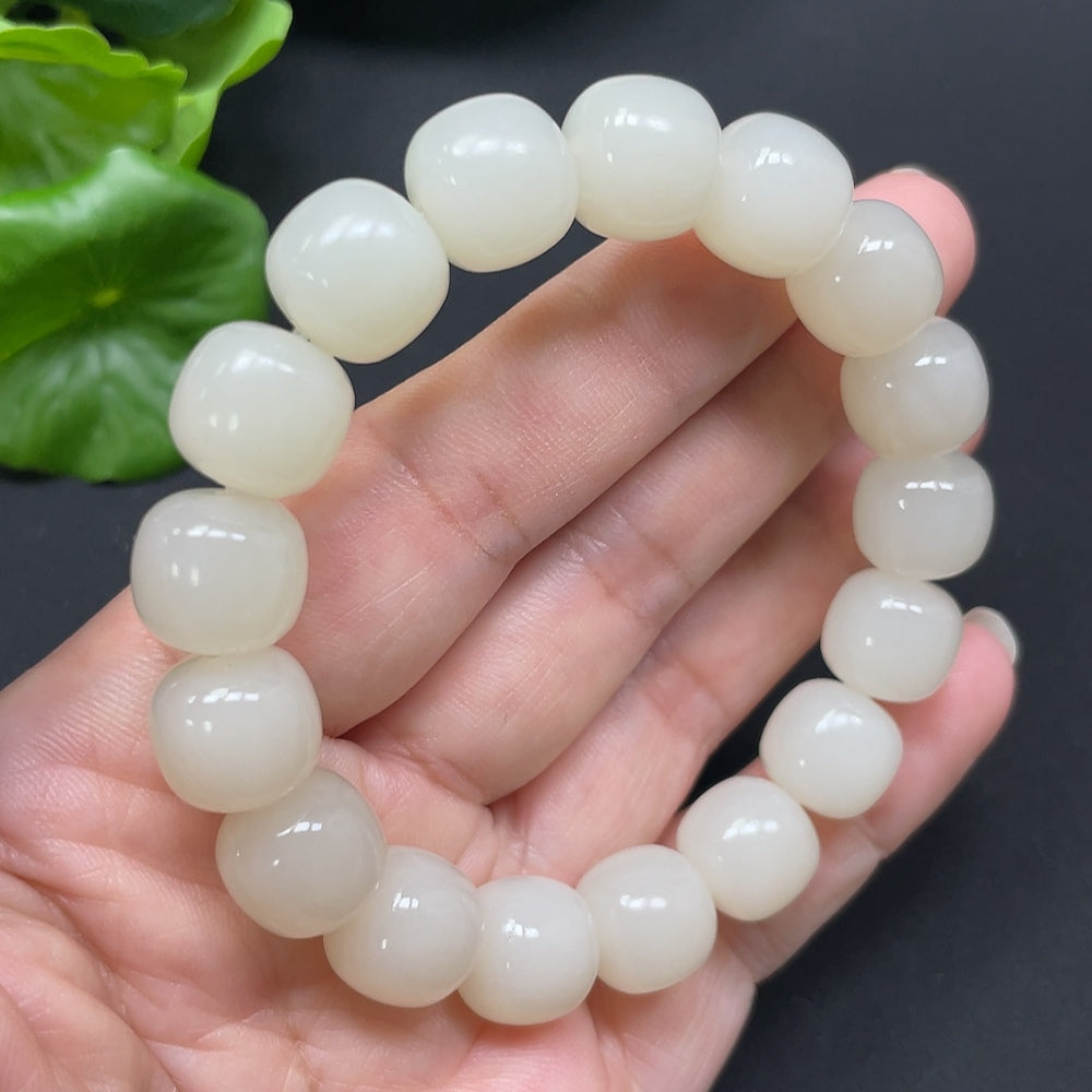 Hetian Jade bracelet with 12mm beads, weighs approximately 49.78g, featuring smooth, polished green jade stones from HKHQ.