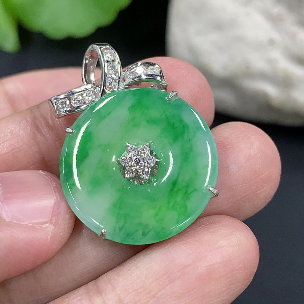 Jadeite Peace Knot pendant in 18k gold with diamond accents, displayed on a necklace chain, weighing approx. 6.8g.