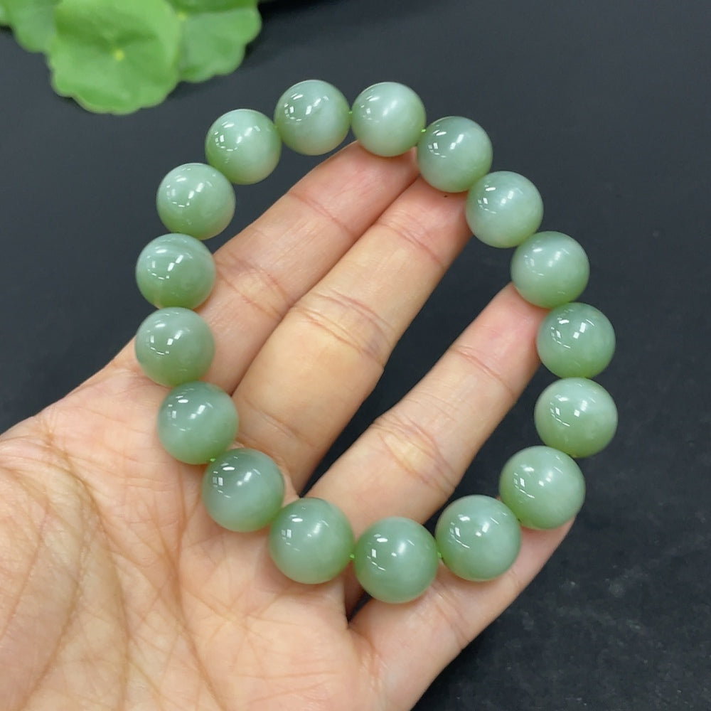 HKHQ Hetian Jade bracelet with 11.6mm beads, weighing approximately 43g, showcasing smooth, polished jade stones.