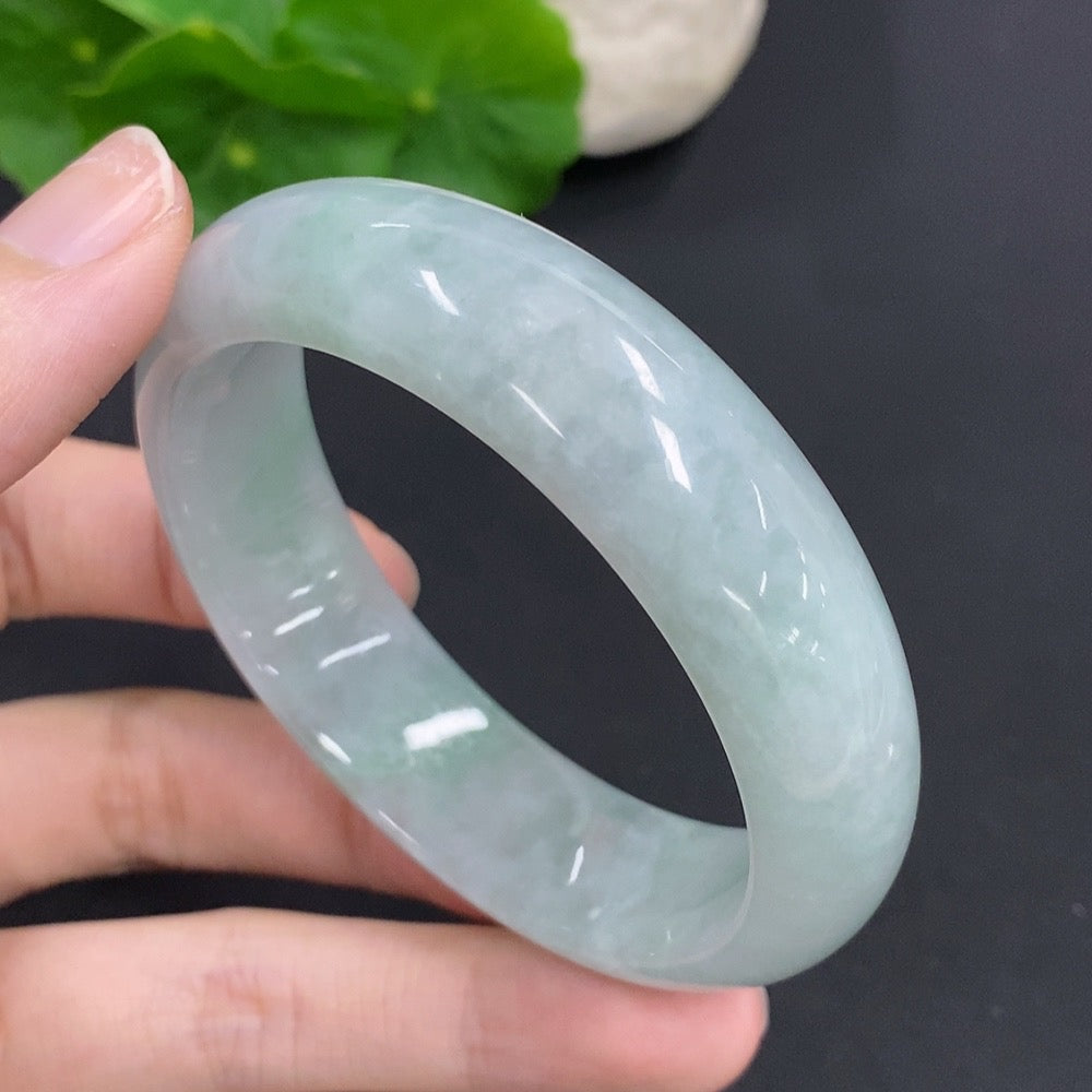 HKHQ jadeite round bangle, 54.5mm size, weighs approximately 64.6g, showcasing smooth, polished green jade jewelry.