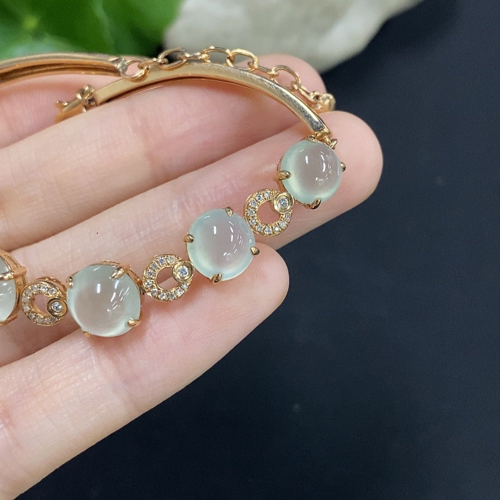 Jadeite cabochon bracelet set in 18K gold with diamond accents, total weight approximately 10.85g