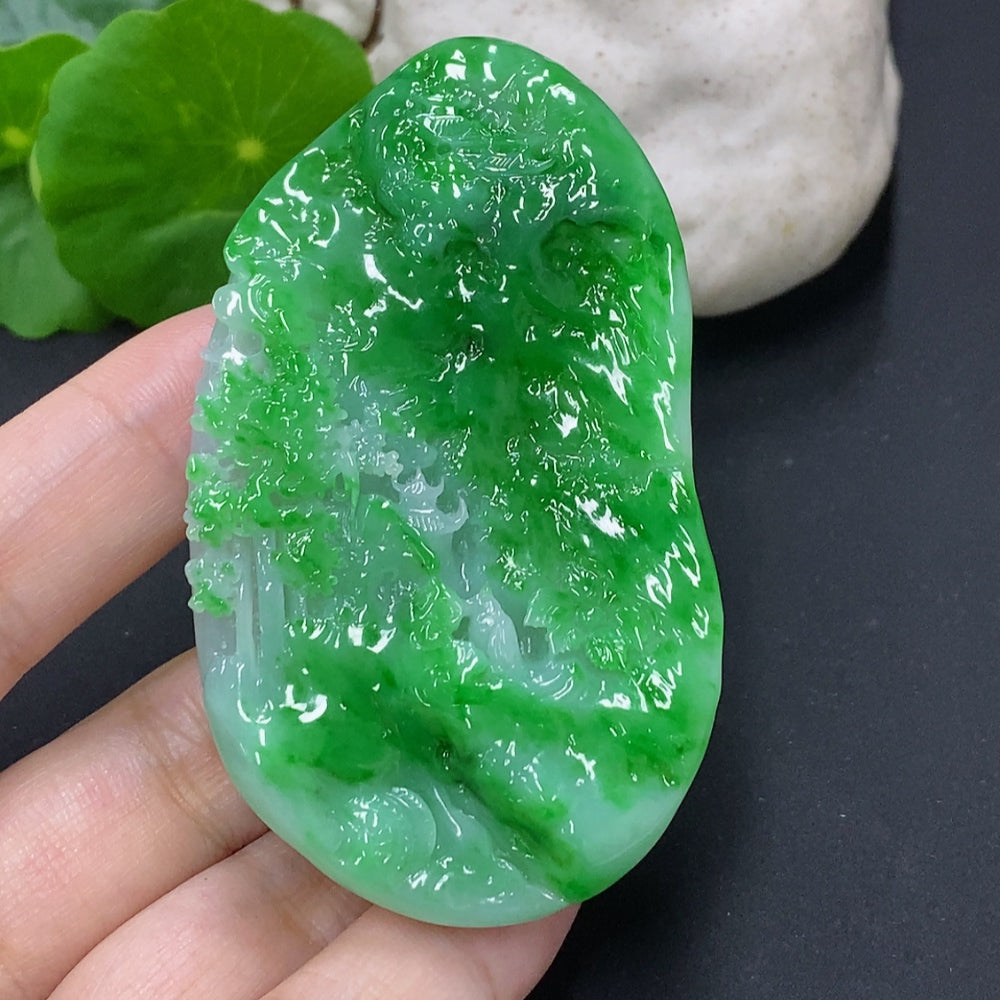 Jadeite landscape pendant from HKHQ featuring intricate carved jade in natural green hues, weighs approximately 65.3 grams.