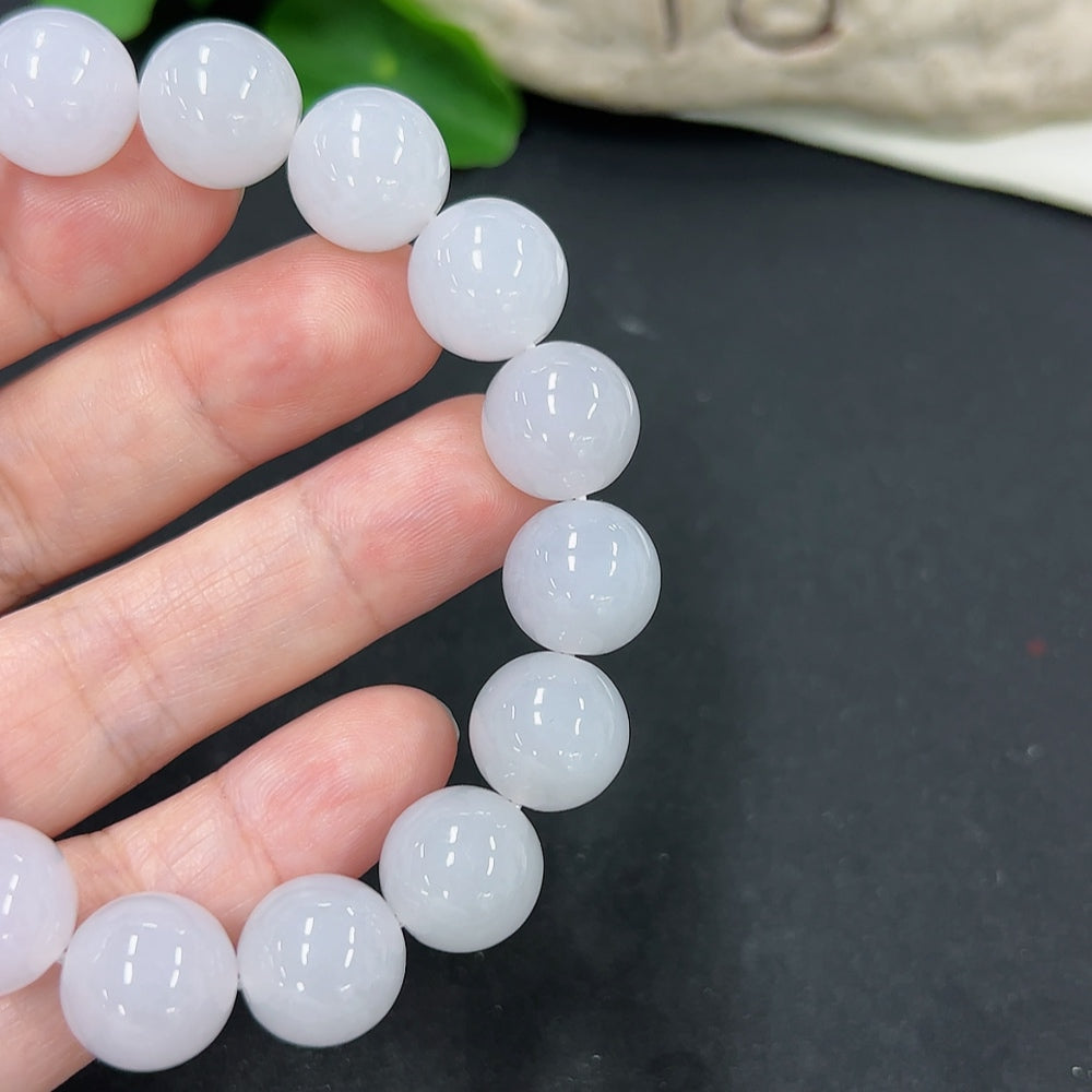 HKHQ jadeite bracelet with 12.8mm beads, weighing approximately 58.1g, showcasing smooth, polished jadeite stones.