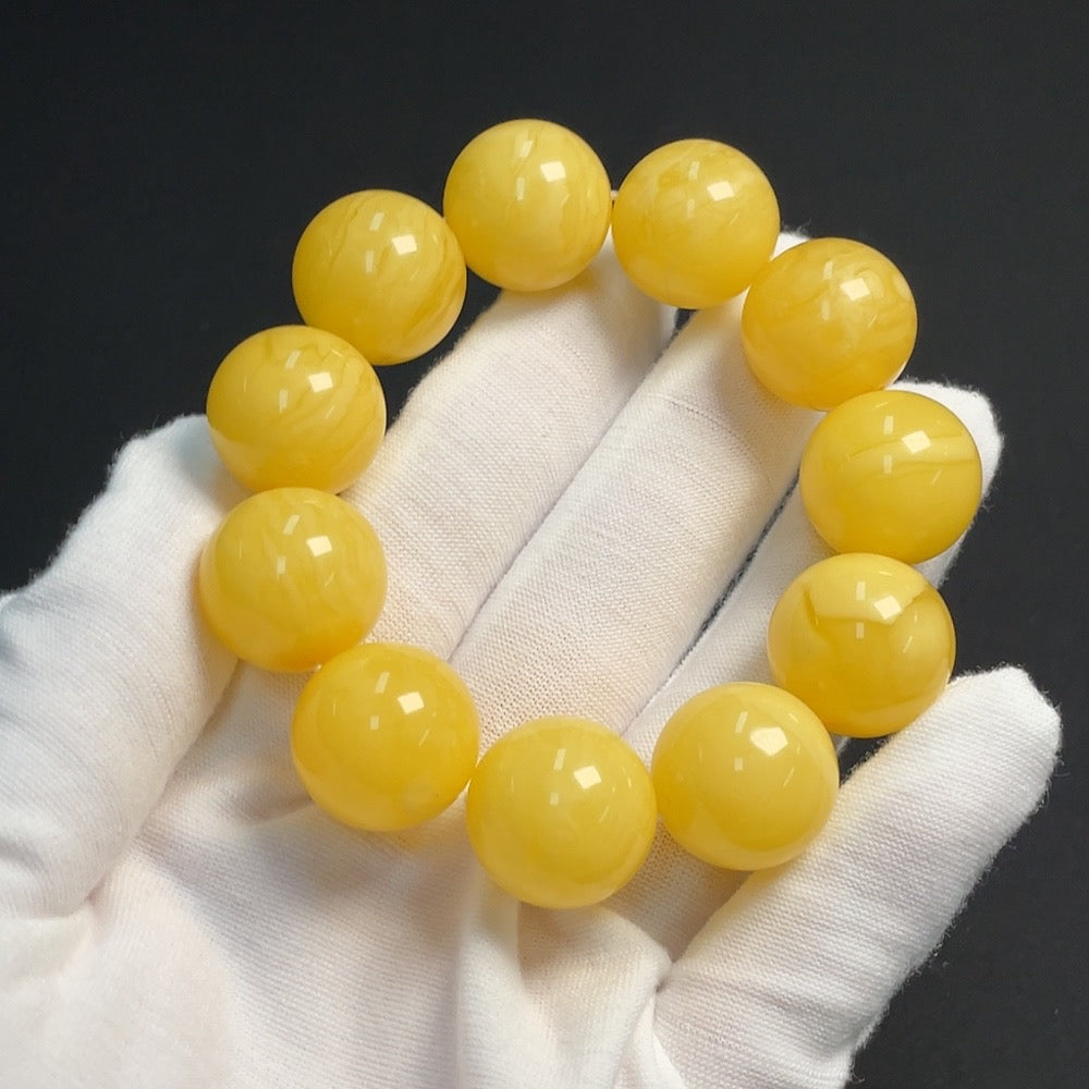 Amber beeswax gemstone bracelet with 17.5mm beads, weighing approximately 34g, featuring natural amber and beeswax accents.