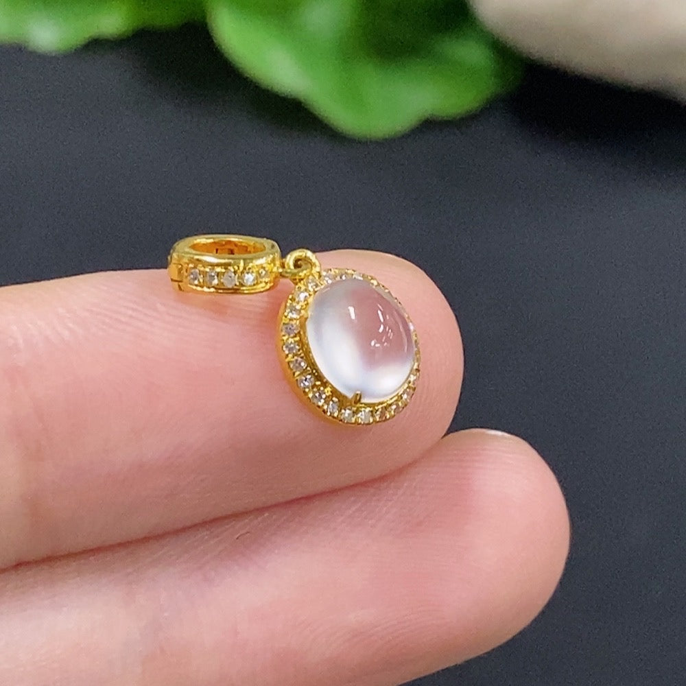 Jadeite cabochon pendant with 18K gold setting and diamond accents, showcasing elegant jewelry craftsmanship.