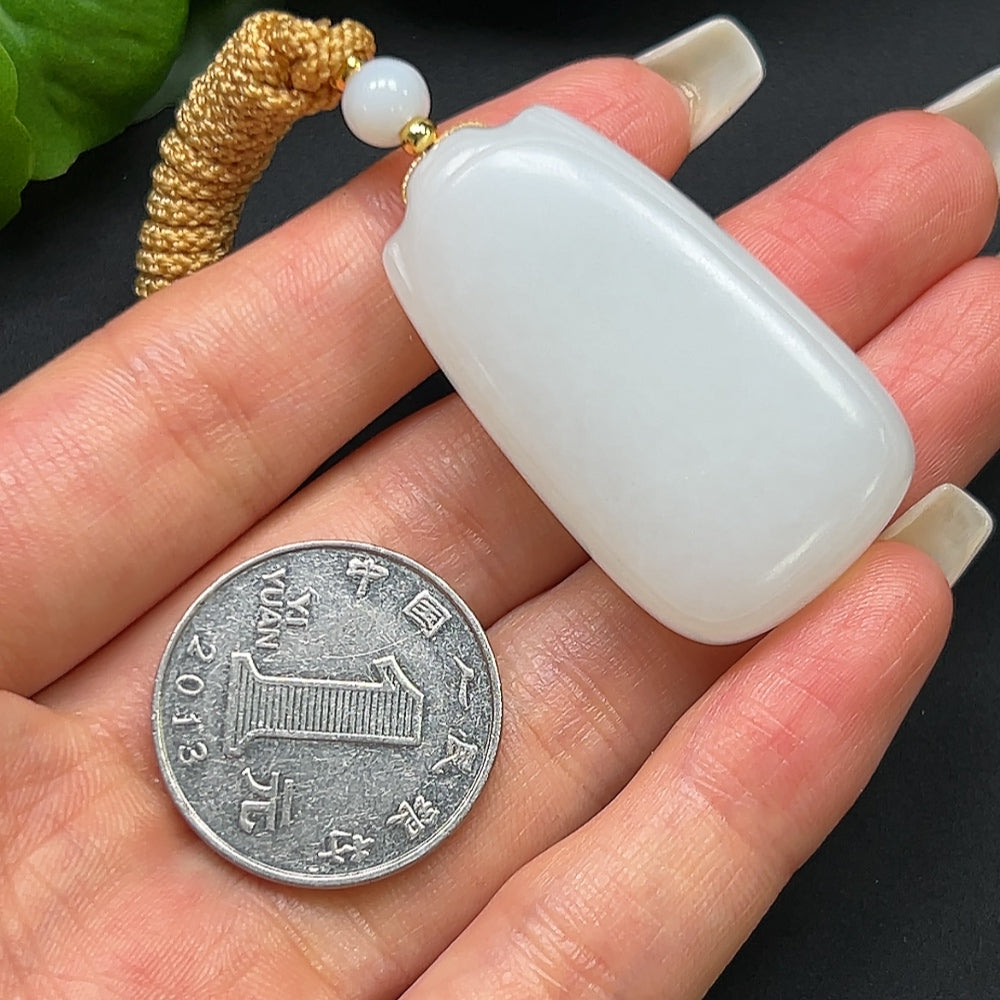 HKHQ Hetian Jade plain pendant with rope, approximately 27.31g, showcasing smooth, polished jade surface and traditional design.