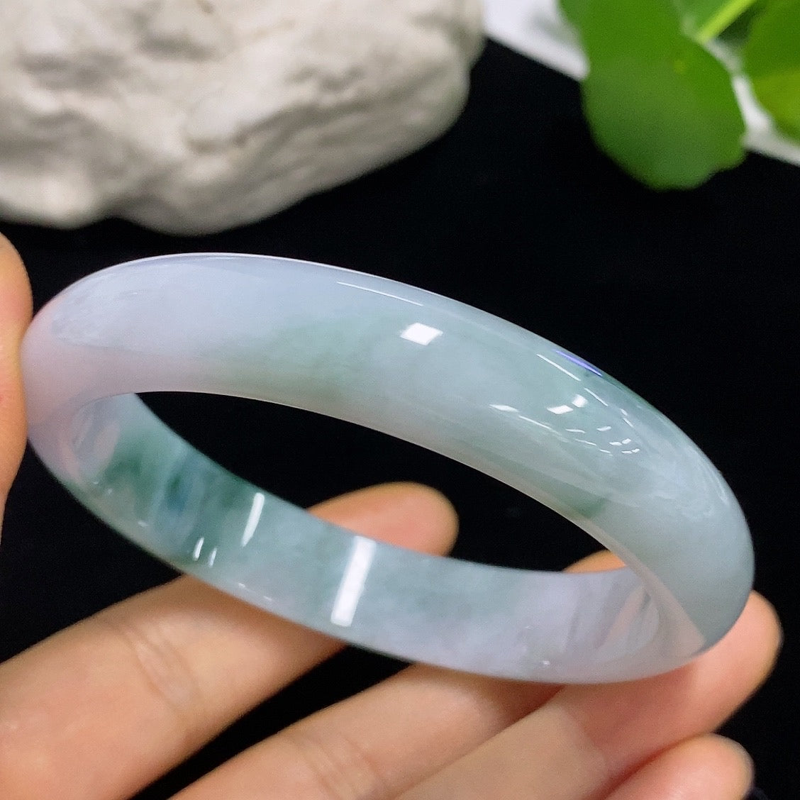 Jadeite round bangle with size 57.3, weighing approximately 50.05g, from HKHQ, showcasing smooth, polished jade surface.
