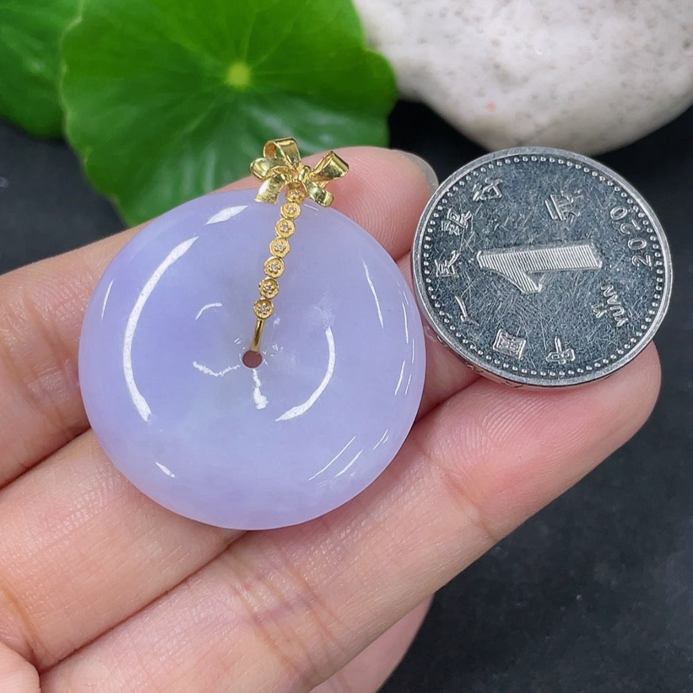 Jadeite pendant with peace buckle design, 18K gold accents and diamond details, from HKHQ, weighing approximately 9.9 grams.