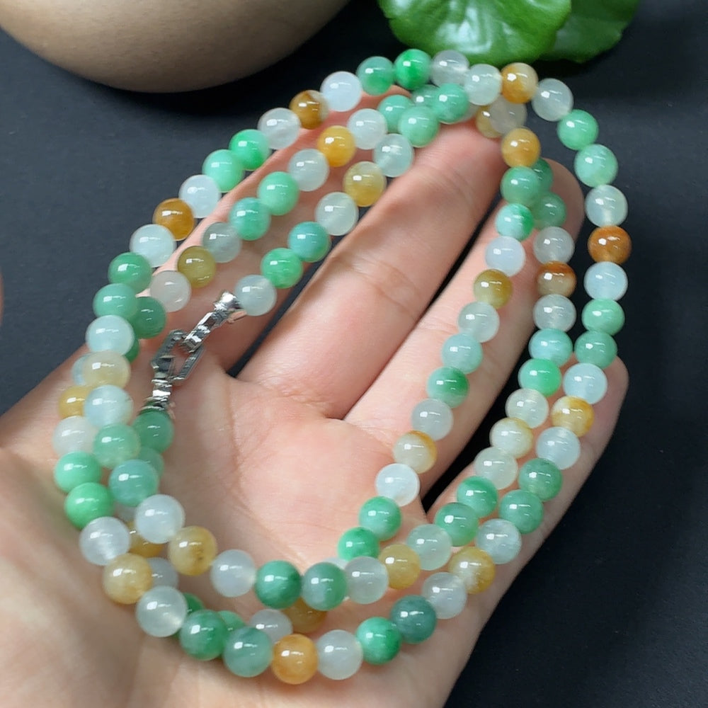 Jadeite bead strand with 5.9mm beads, non-gold card, weighing approximately 42.38g, featuring smooth, polished jade stones.