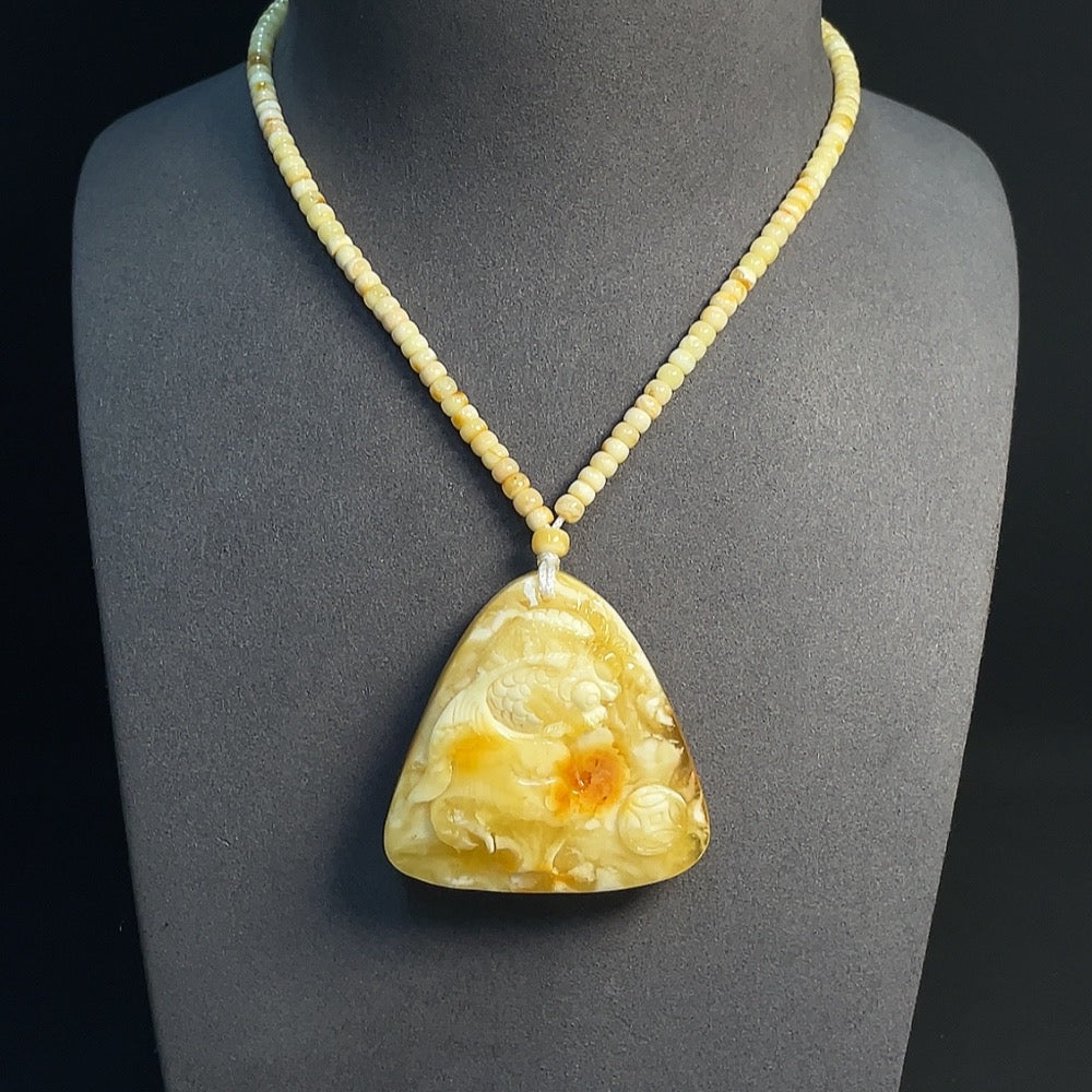Amber beeswax pendant with colorless coating, partial repairs visible, HKHQ brand, includes cord and collection certificate.