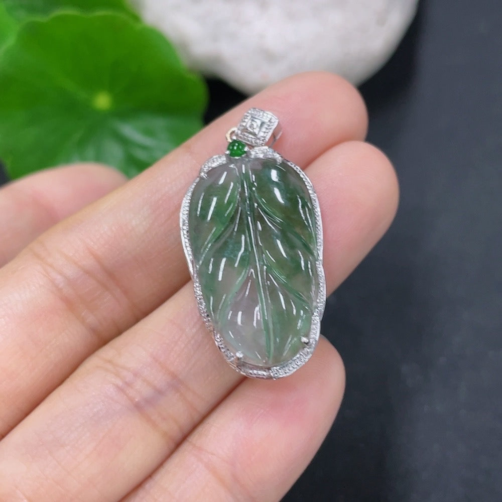 Jadeite leaf pendant by HKHQ with 18K gold and diamond accents, showcasing detailed jade leaf design and sparkling accents.