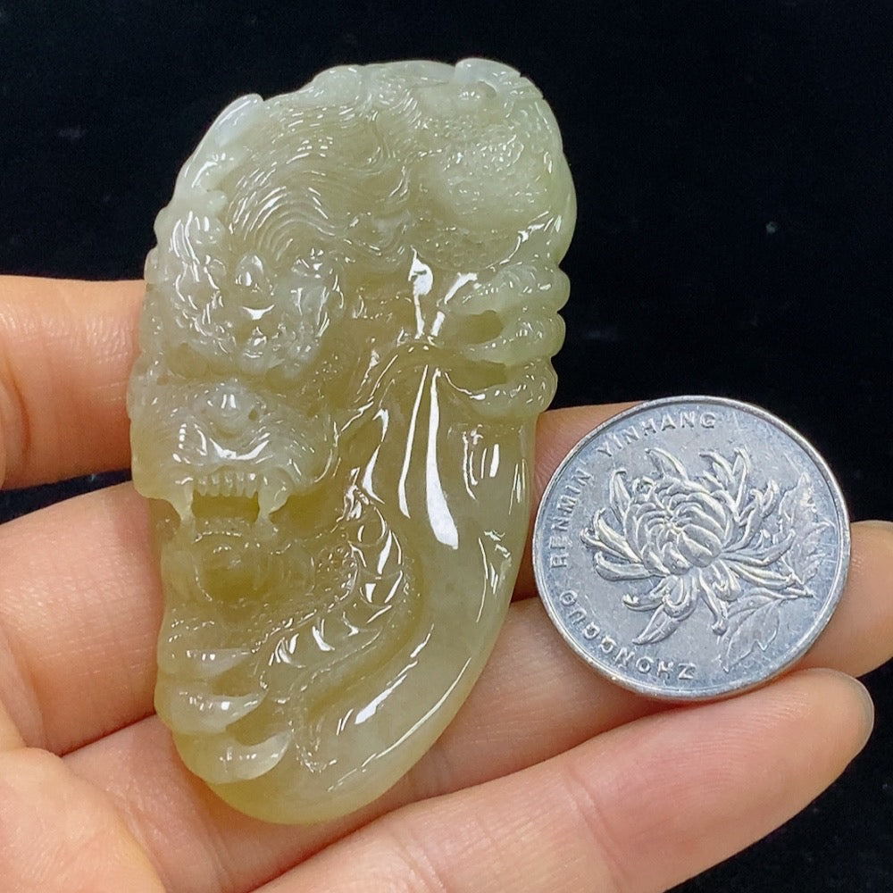 Jadeite dragon pendant in jade, approximately 34.7g, crafted by HKHQ, featuring detailed dragon design on smooth green jade surface.