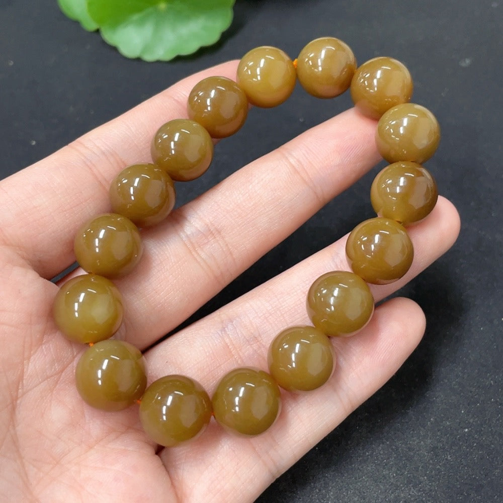 Hetian jade bracelet with 11.6mm beads, crafted by HKHQ, showcasing smooth, polished green jade stones on a white background.