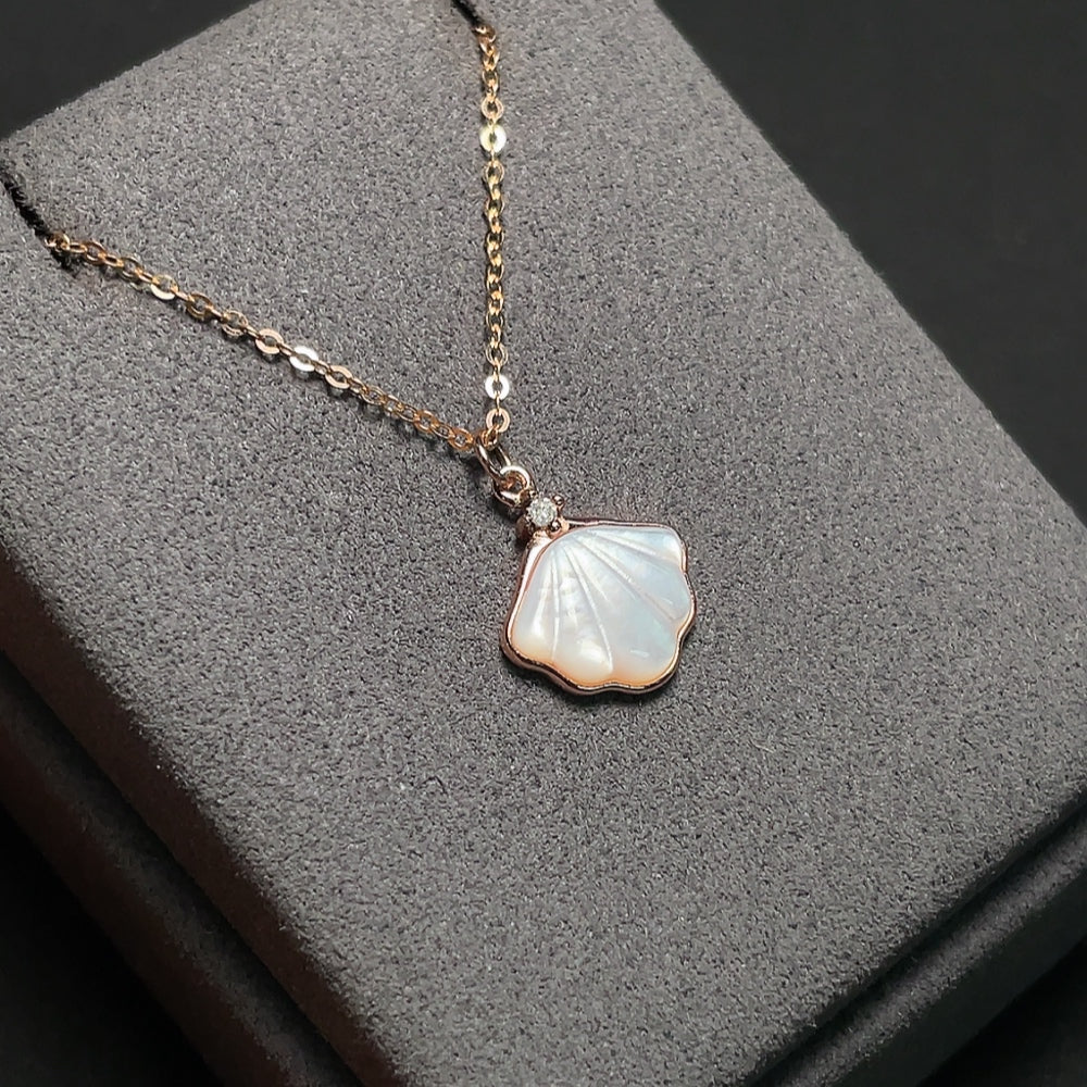 Shell pendant with diamond accents, 18K gold chain (pendant not gold), total weight approximately 2.72g including chain
