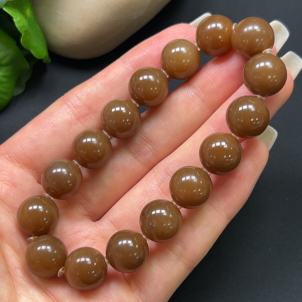 Hetian jade bracelet with 12.1mm beads, weighing approximately 43.69 grams, featuring smooth, polished jade stones from HKHQ.