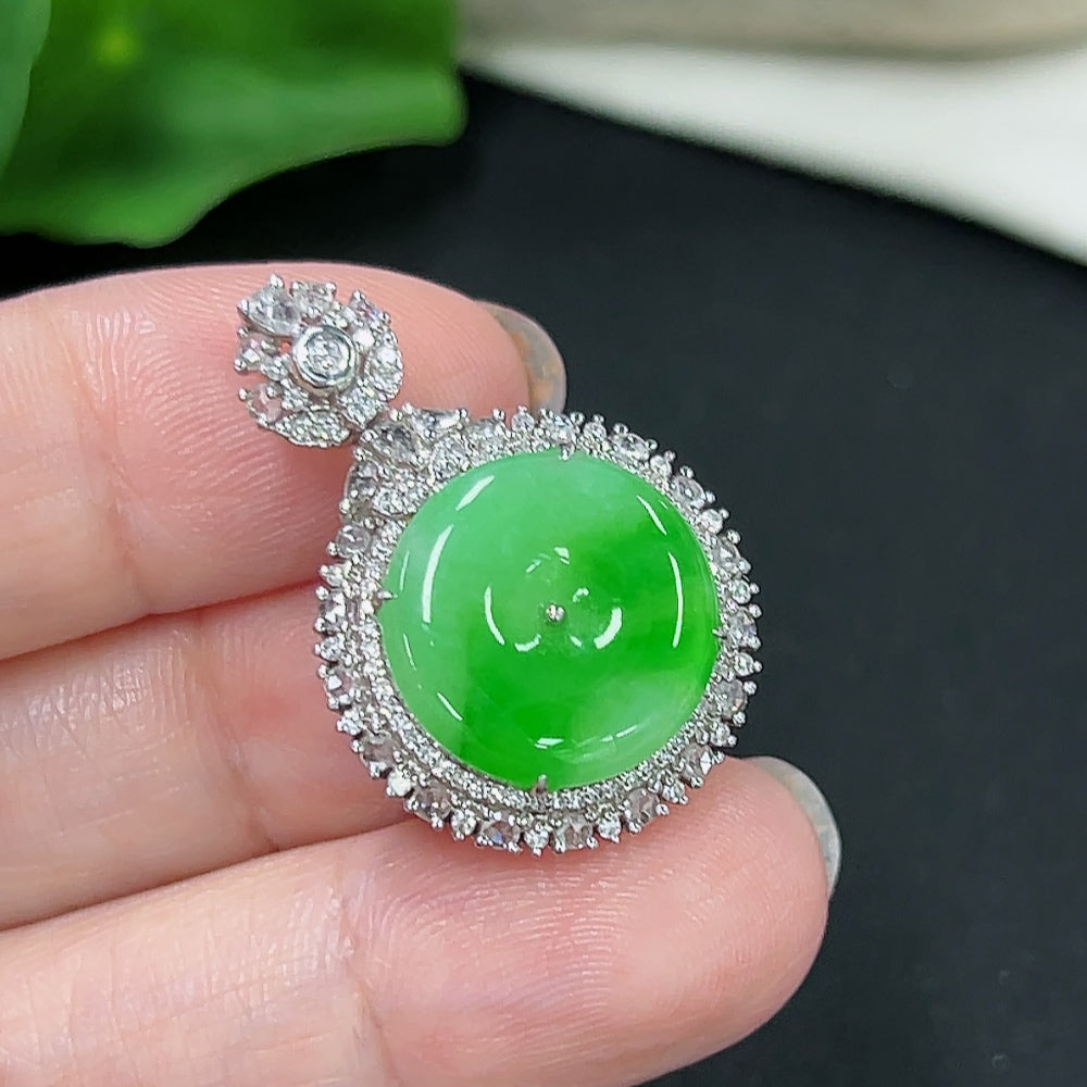 Jadeite pendant with 18K gold setting, accented with diamonds, showcasing a polished jade stone and elegant design.