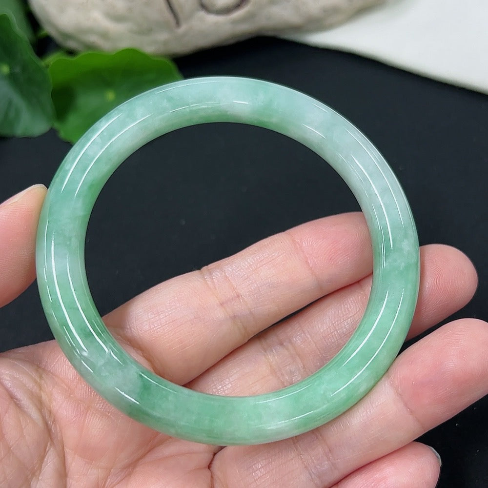 HKHQ jadeite round bangle, size 56 with a total weight of 43.02g, showcasing smooth, polished green jadeite bracelet.
