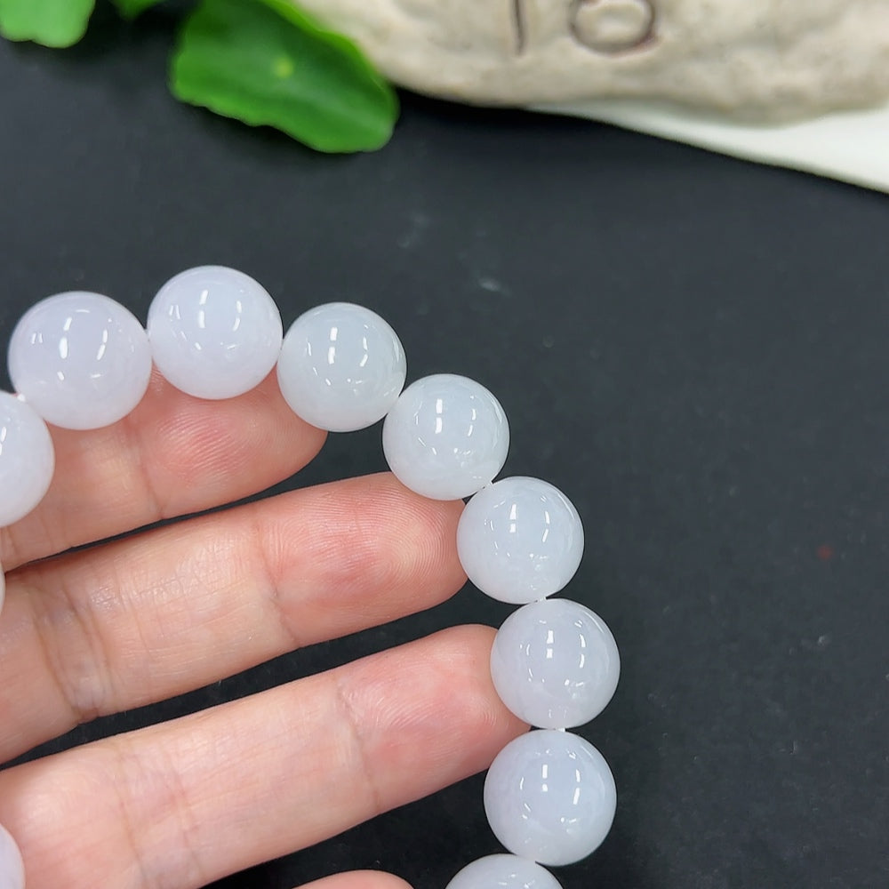 Jadeite bracelet with 12.8mm beads, approximately 58.1g, featuring smooth, polished green jadeite stones.