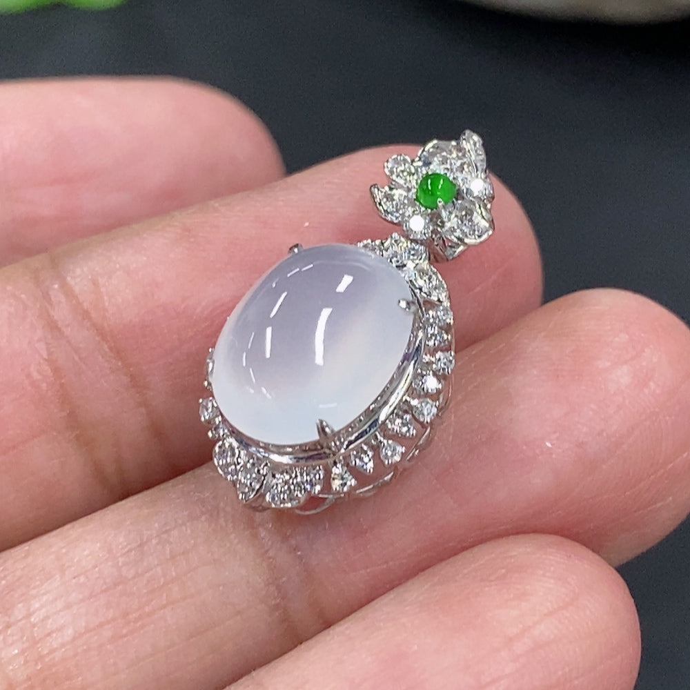 Jadeite cabochon pendant with 18K gold setting and diamond accents, featuring a polished green jade stone and delicate gold details.