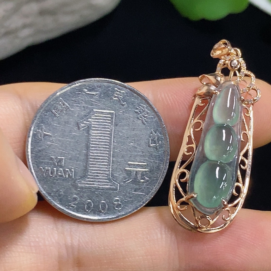 Jadeite auspicious bean pendant with 18K gold accents and diamond details, weighing approximately 2.23 grams.