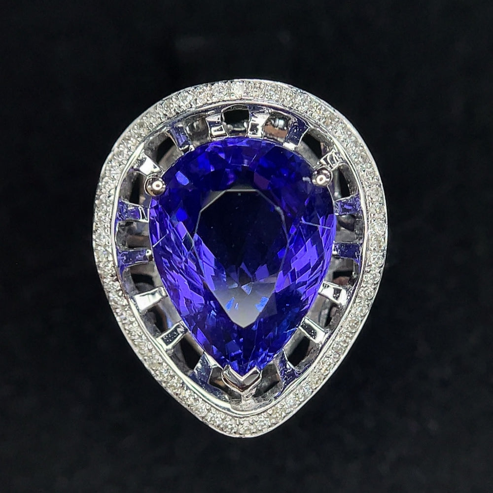 18K gold Tanzanite ring with diamond accents, size 11, weighs approx. 4.41g, featuring vibrant blue gemstones and sparkling diamonds.