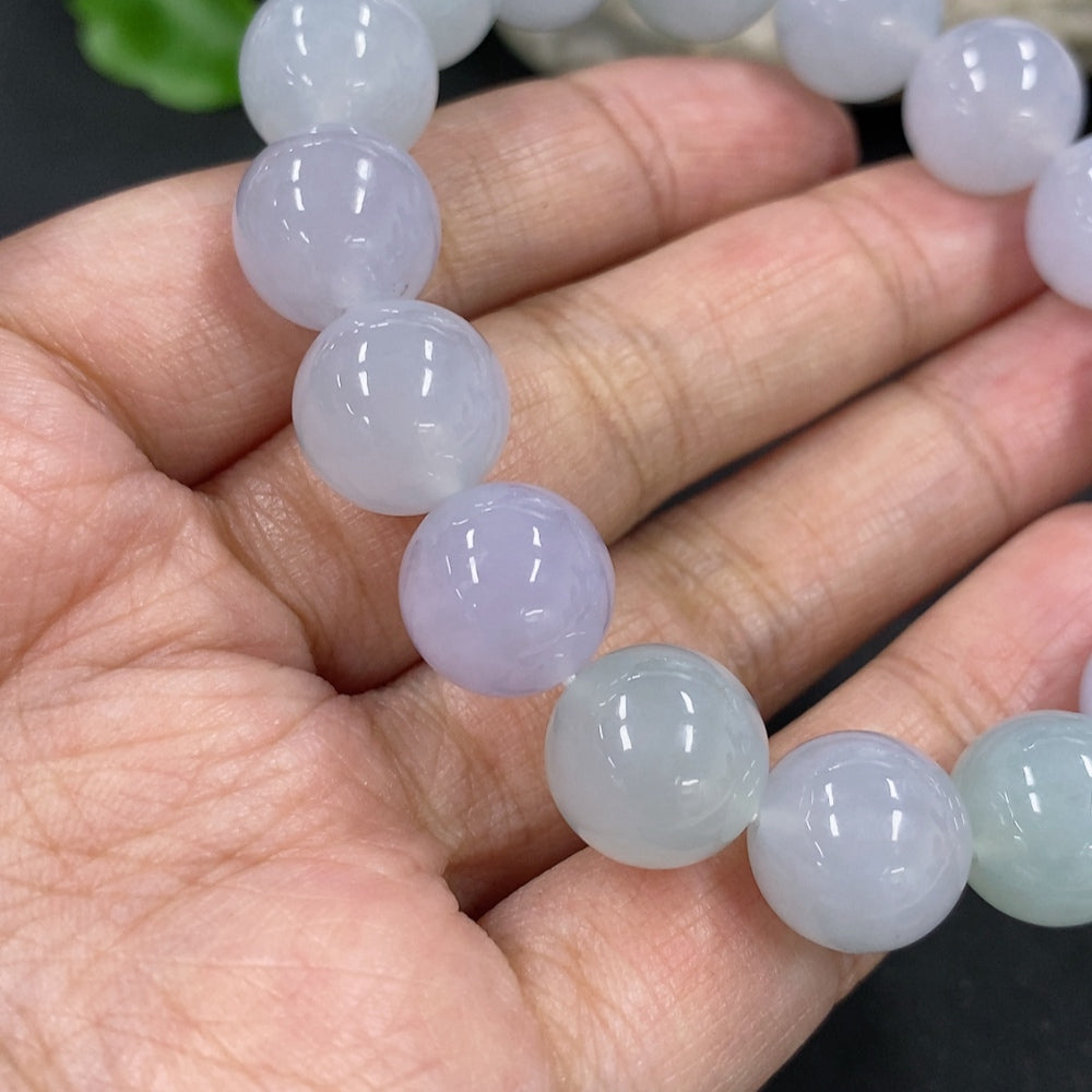 HKHQ jadeite bracelet with 12mm beads, approximately 49.7g, showcasing smooth, polished jadeite stones on a delicate bracelet.