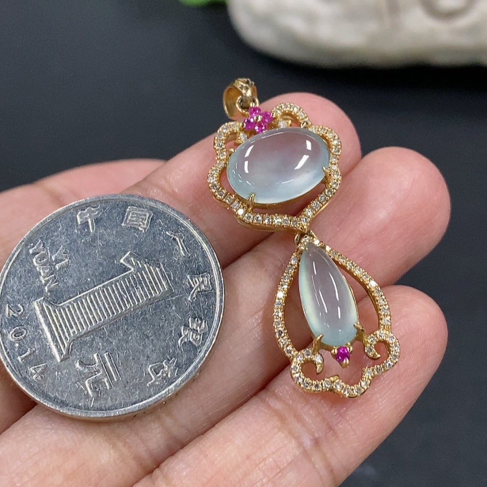 Jadeite cabochon pendant with 18K gold setting and diamond accents, showcasing a smooth green jade gemstone and elegant design.