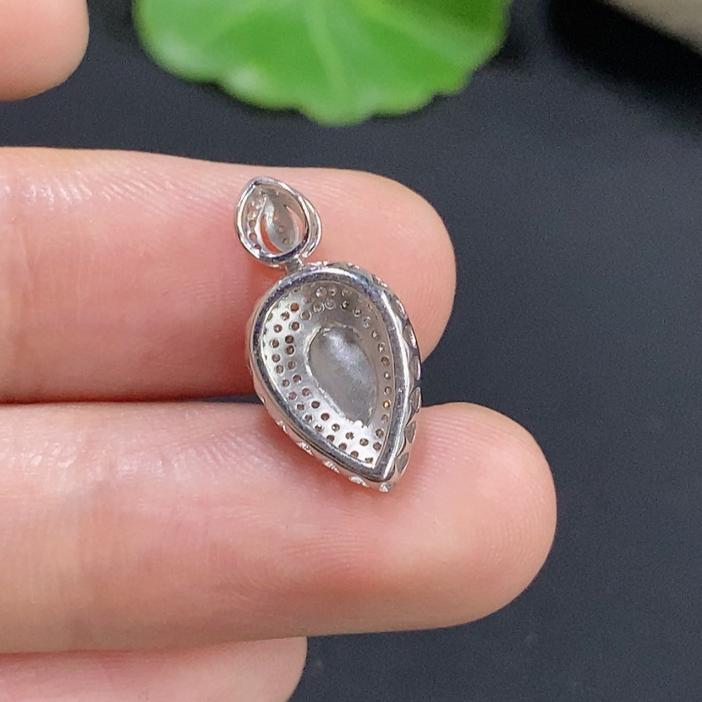 Elegant Jadeite inlaid pendant with 18k gold and diamond accents, featuring a delicate design on a necklace.