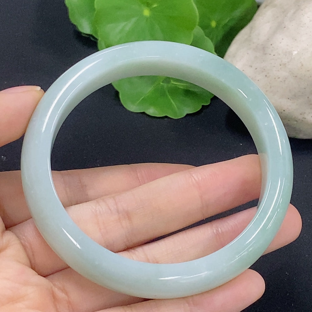 HKHQ jadeite round bangle, size 58.9 with approximately 56.8g, showcasing smooth, polished jadeite surface and elegant design.