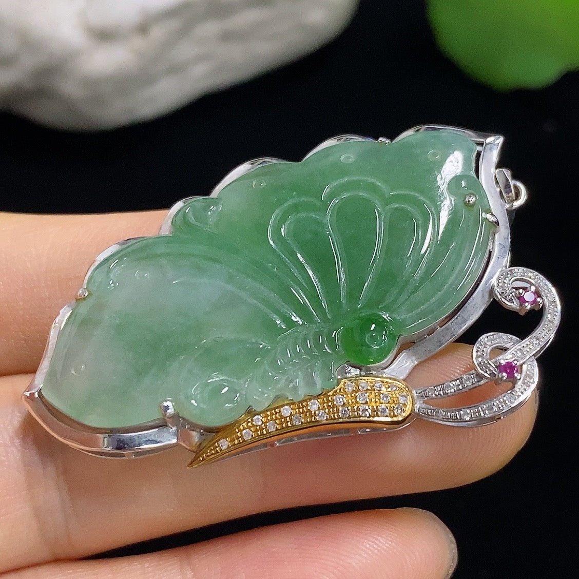 Jadeite butterfly pendant with 18k gold accents and diamond details, showcasing intricate craftsmanship and elegant design.