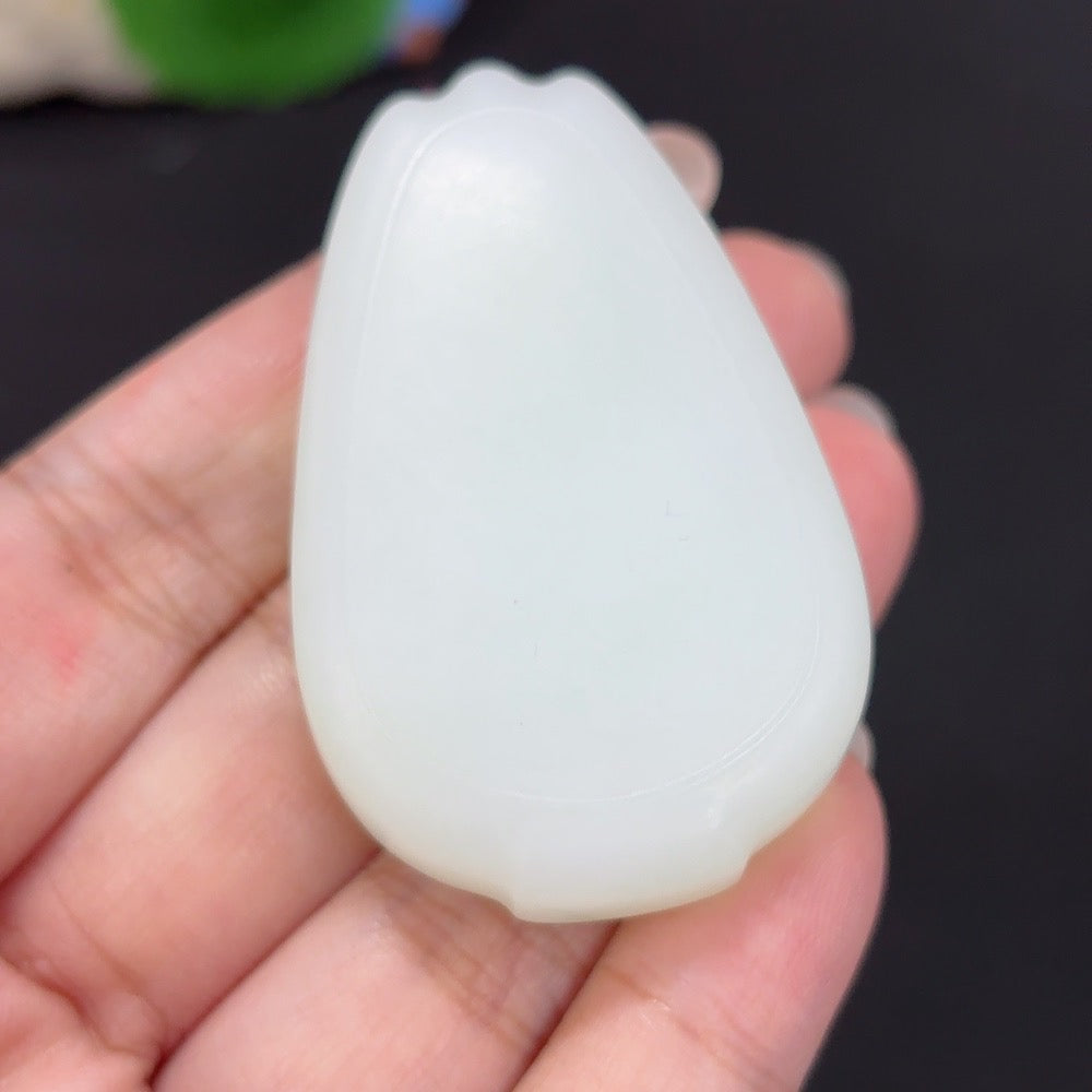 HKHQ Hetian jade pendant with plain design, weighs approximately 48.1g, shown with cord, showcasing smooth, polished jade surface.