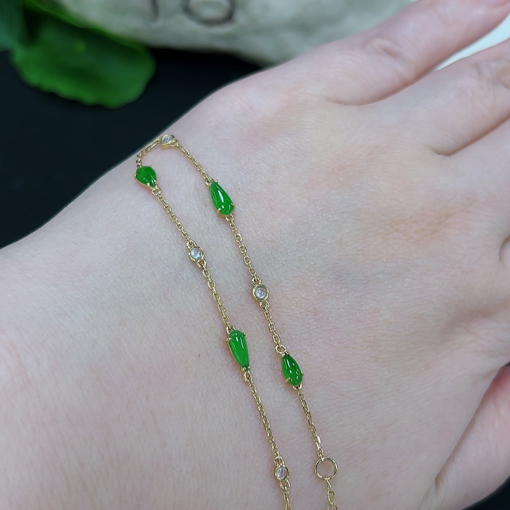 Elegant jadeite inlaid bracelet with 18K gold accents, featuring intricate craftsmanship and a lightweight design.