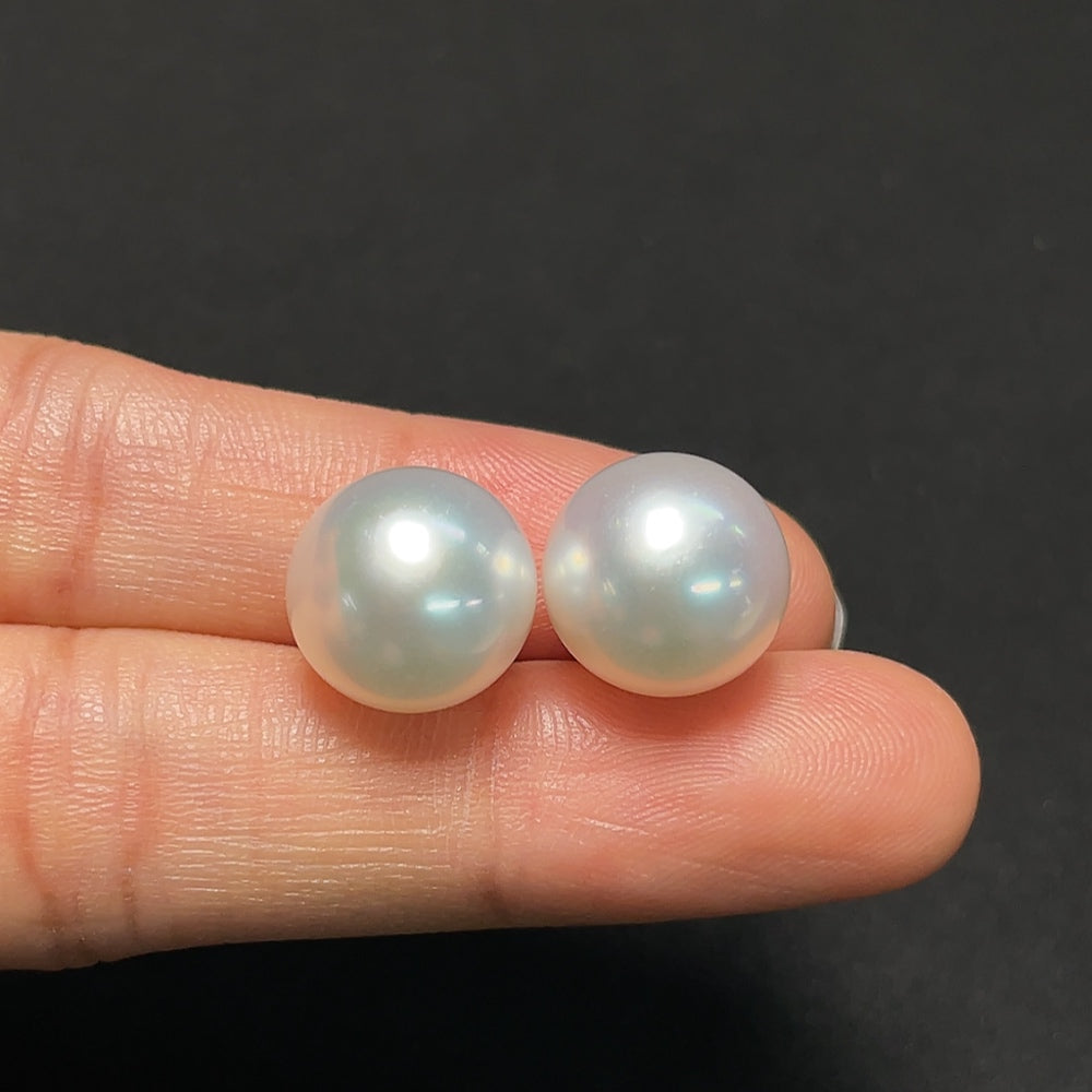 Saltwater pearl earrings by HKHQ featuring 18K gold settings, showcasing elegant round pearls and fine jewelry craftsmanship.