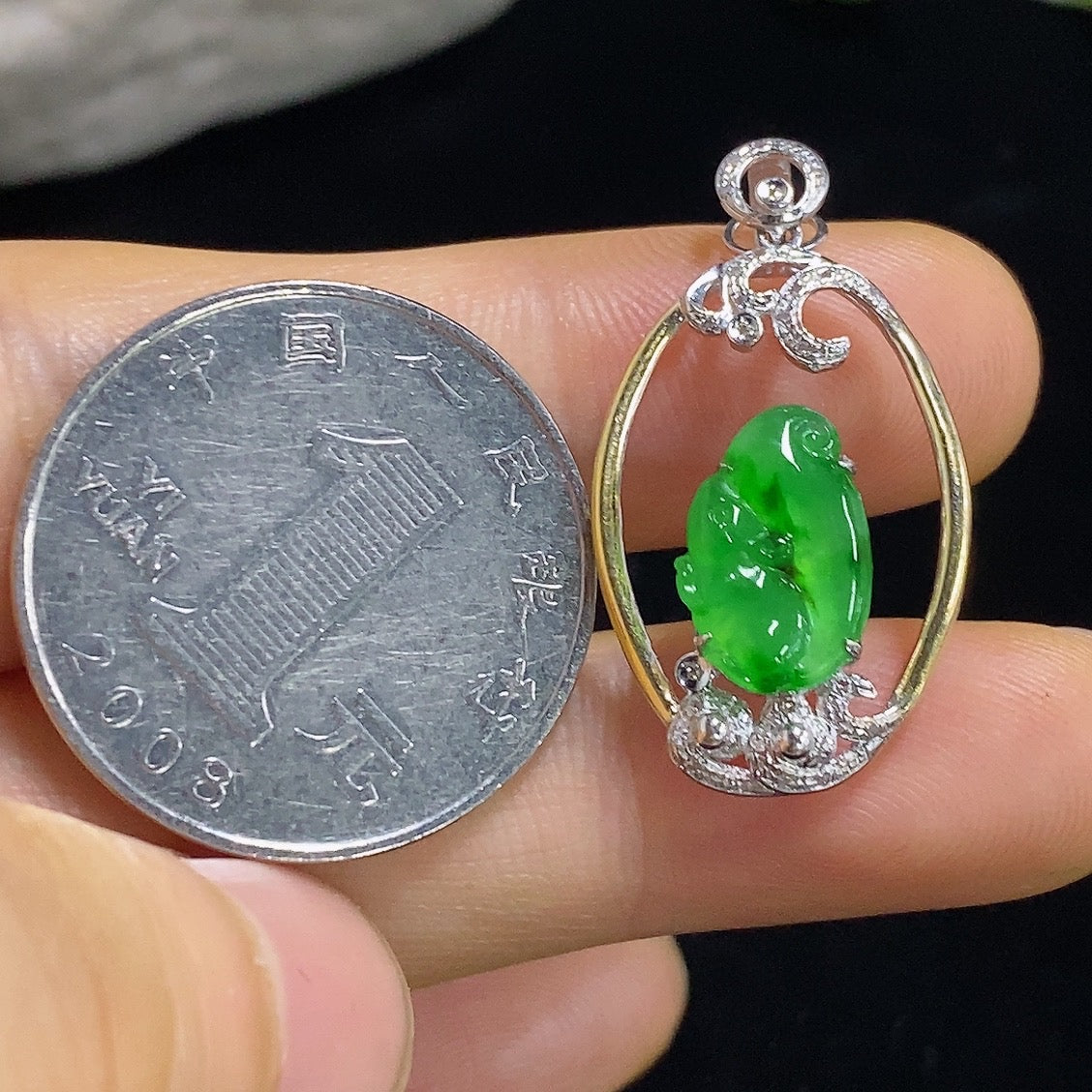 Jadeite inlaid pendant with 18k gold and diamond accents, showcasing detailed craftsmanship and elegant design.