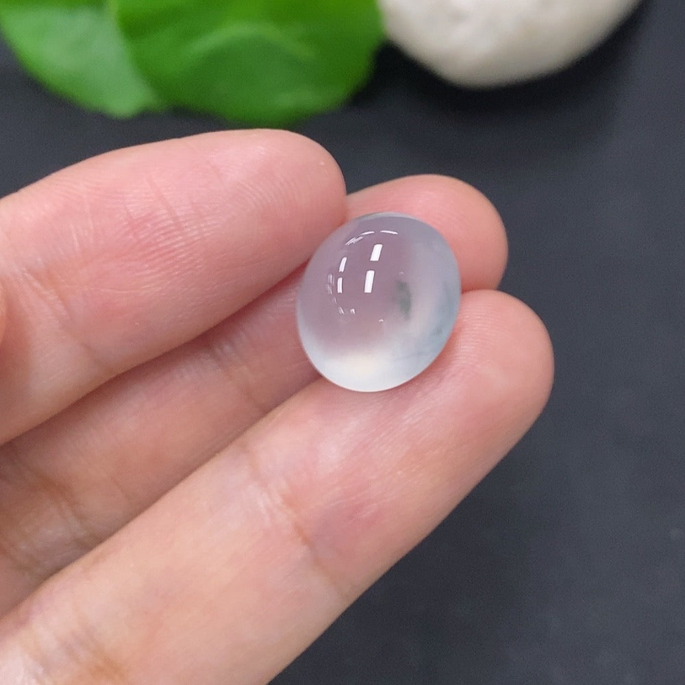 Jadeite cabochon jewelry piece from HKHQ, weighing 2.2g, with a smooth, polished surface showcasing vibrant green color.