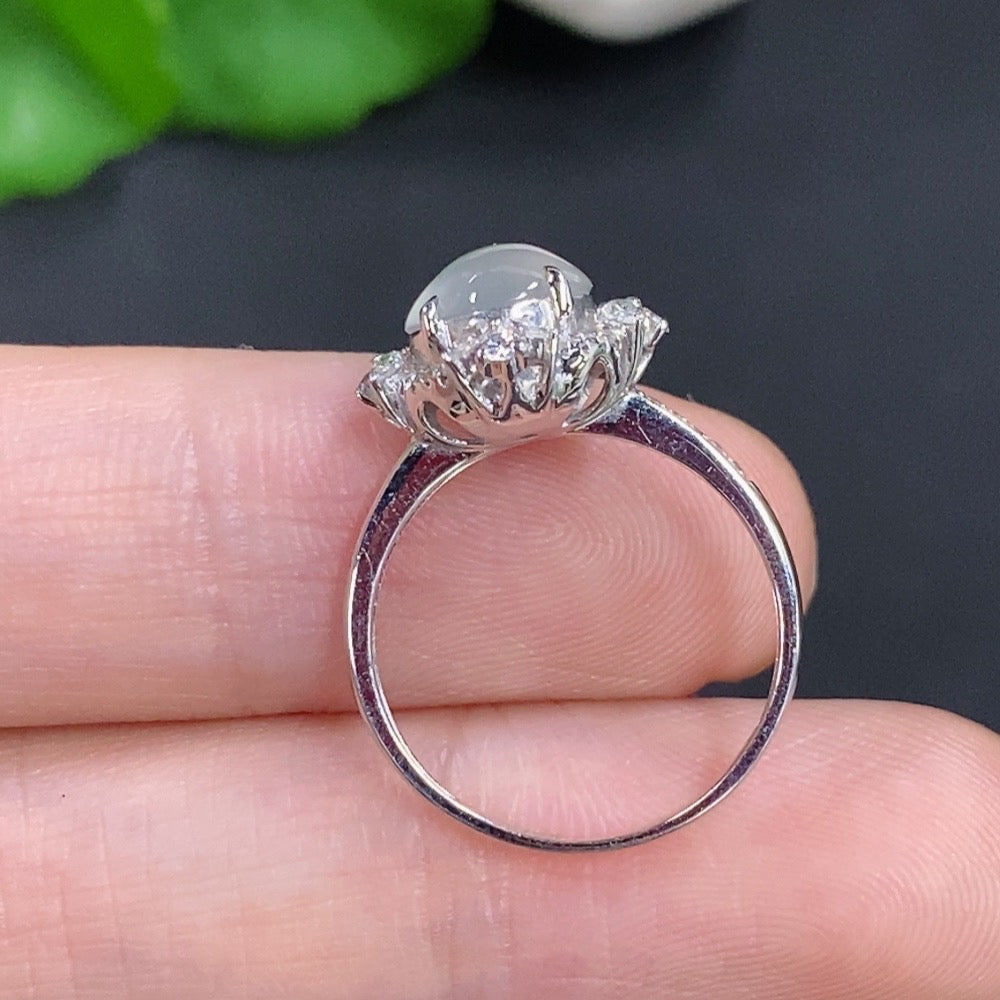 Jadeite cabochon ring by HKHQ with 18k gold setting, accented with small diamonds, size 10, weighs approximately 2.7g.