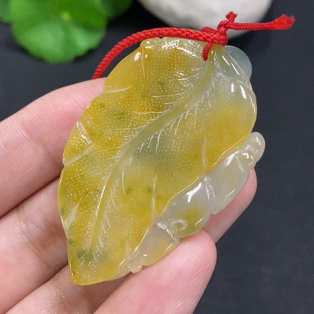 Jadeite pendant with cord, total weight approximately 25.2g (color origin undetermined)