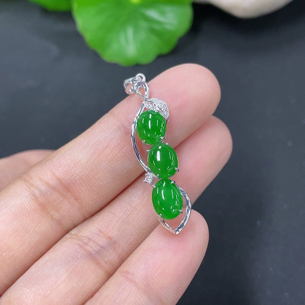 Jadeite bezel-set cabochon pendant with 18k gold and diamond accents, featuring a smooth, polished jade stone.