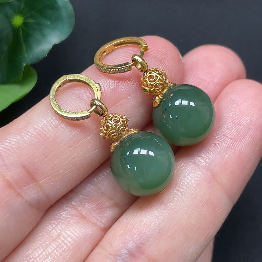 Hetian jade earrings with 18K gold and diamond accents, measuring 11.6mm, weighing approximately 6.79g.