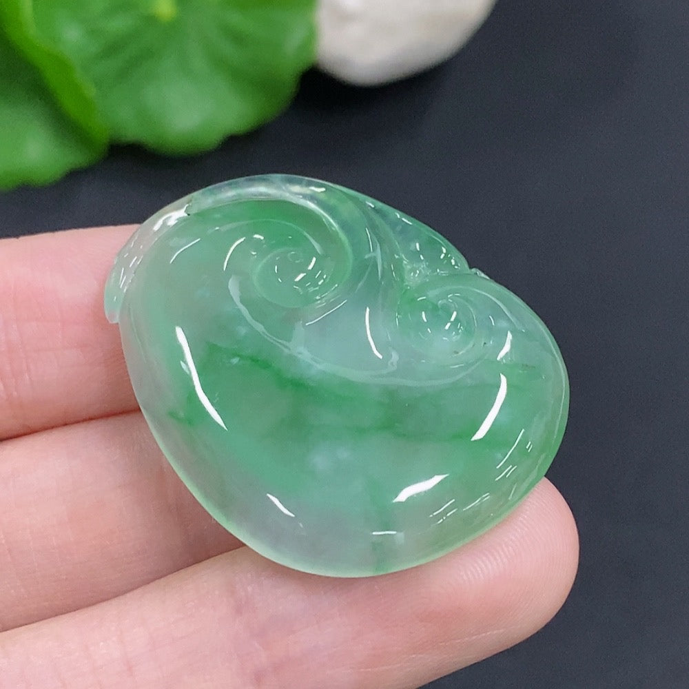 Jadeite Ruyi pendant with intricate carvings, weighing approximately 10.5g, crafted by HKHQ, showcasing smooth, polished jade surface.